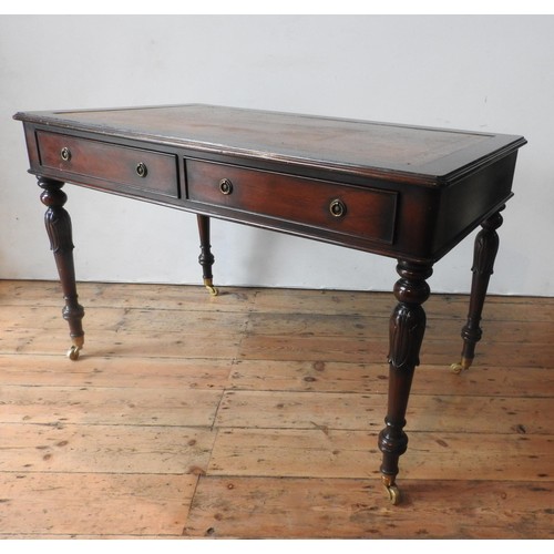 57 - A 20TH CENTURY MAHOGANY REGENCY STYLE LIBRARY TABLE, with leather top, the legs carved with tulip de... 