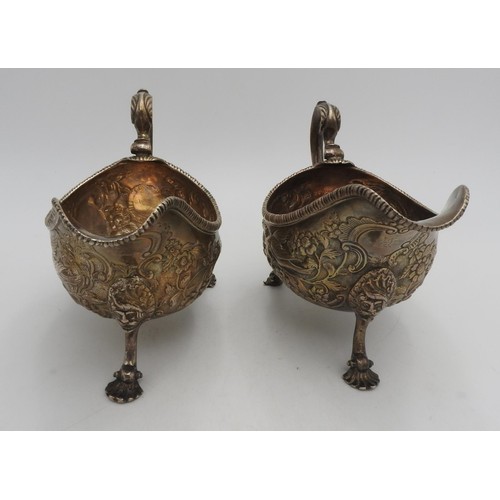 319 - A PAIR OF LARGE IRISH HALLMARK SILVER SAUCEBOATS, with extensive foliate and bird embossed decoratio... 