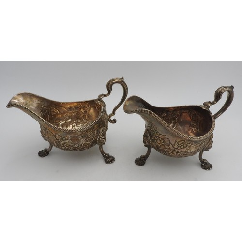 319 - A PAIR OF LARGE IRISH HALLMARK SILVER SAUCEBOATS, with extensive foliate and bird embossed decoratio... 