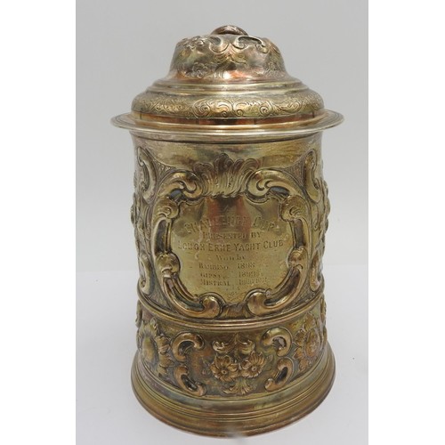 320 - A GEORGE III HALLMARK SILVER TANKARD WITH LID, 1763 with extensive floriform embossed decoration thr... 