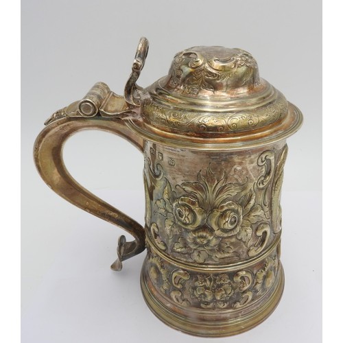 320 - A GEORGE III HALLMARK SILVER TANKARD WITH LID, 1763 with extensive floriform embossed decoration thr... 