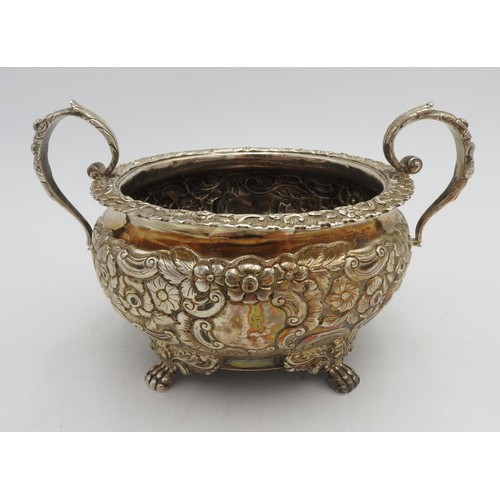 321 - AN ORNATE IRISH HALLMARK SILVER BOWL WITH TWO HANDLES, embossed with ornate floral design, two scrol... 