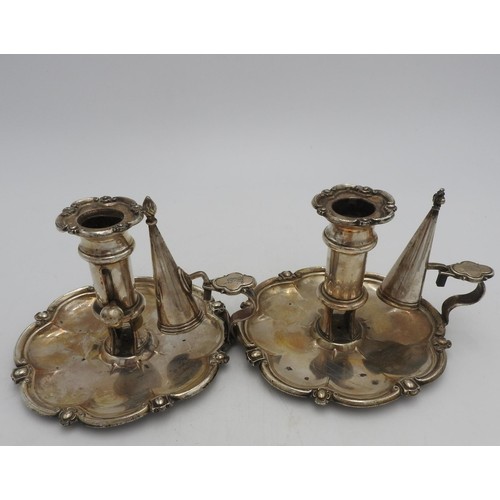 322 - A PAIR OF SILVER PLATED ADJUSTABLE CHAMBER STICKS WITH CANDLE SNUFFERS, the bases in a tudor rose fo... 