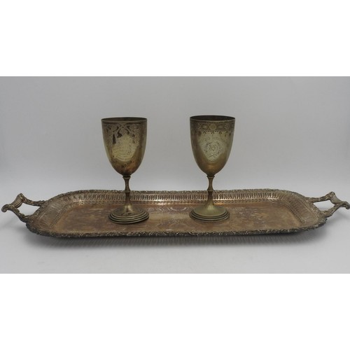 323 - A LONG TWO HANDLED PLATED TRAY AND TWO VICTORIAN PRESENTATION GOBLETS, the tray with pierced fret wo... 