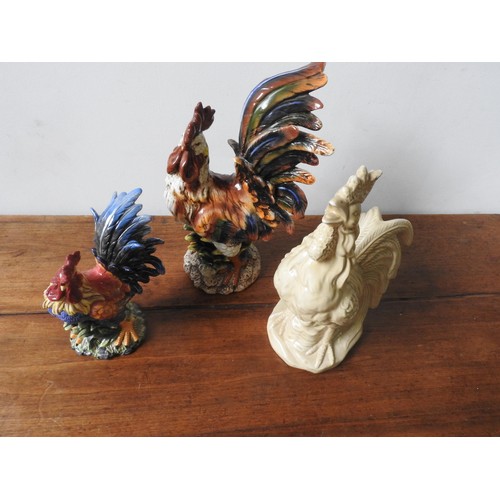 278 - THREE 20TH CENTURY GLAZED COCKEREL ORNAMENTS, two painted and one cream glazed, the largest 48 cm hi... 