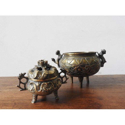 217 - TWO BRONZE CENSERS, the larger with two handles in the form of lions, the smaller in the form of a l... 