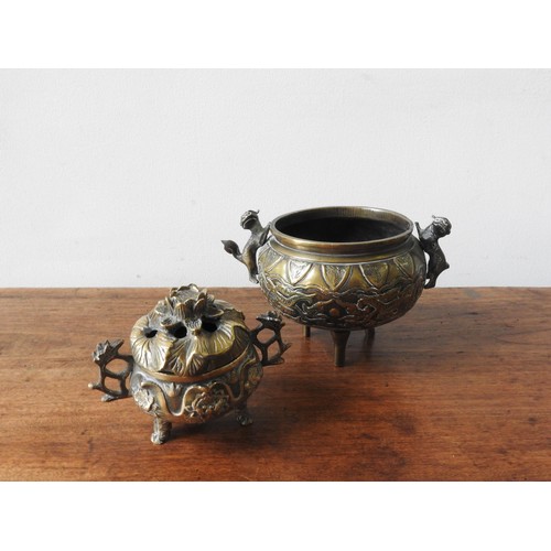 217 - TWO BRONZE CENSERS, the larger with two handles in the form of lions, the smaller in the form of a l... 