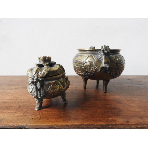 217 - TWO BRONZE CENSERS, the larger with two handles in the form of lions, the smaller in the form of a l... 