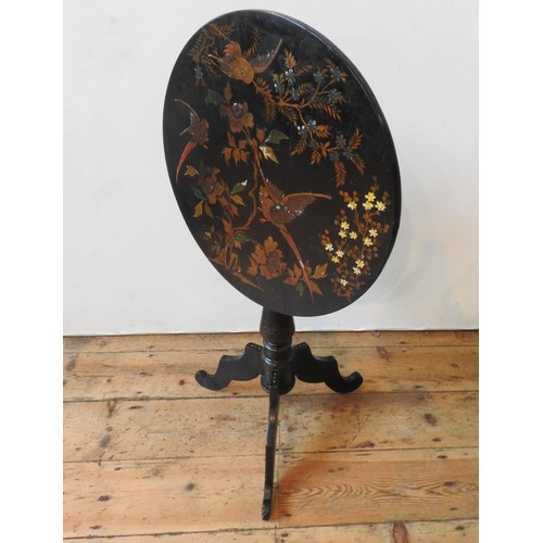 66 - A VICTORIAN JAPANNED TILT TOP TRIPOD TABLE, 75 cm high x 57 cm dia, with foliate and bird painted de... 