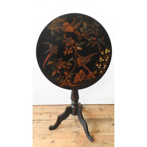 66 - A VICTORIAN JAPANNED TILT TOP TRIPOD TABLE, 75 cm high x 57 cm dia, with foliate and bird painted de... 