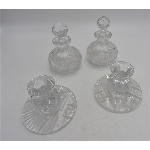 249 - A PAIR OF CUT GLASS SCENT BOTTLES AND A PAIR OF MATCHING CANDLESTICKS, the scent bottles measuring 1... 