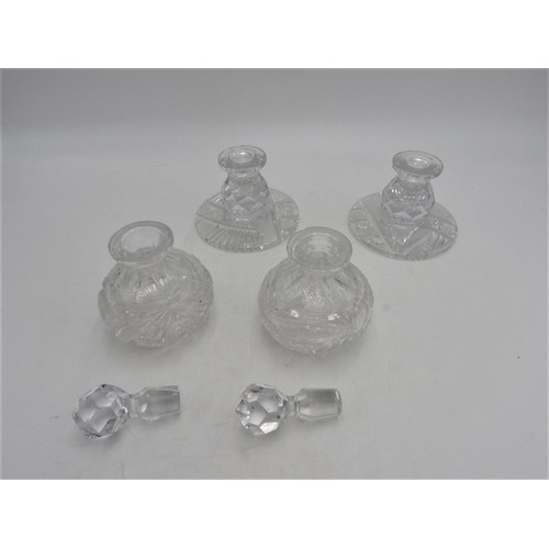 249 - A PAIR OF CUT GLASS SCENT BOTTLES AND A PAIR OF MATCHING CANDLESTICKS, the scent bottles measuring 1... 