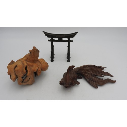 215 - A HARDWOOD CARVED FANTAIL FIGURE, A CARVED TOAD AND AN ORIENTAL BRONZE GATEWAY ORNAMENT