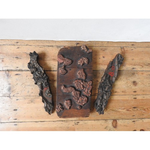 297 - THREE 19th CENTURY CARVED WOODEN PRINTING BLOCKS, carved with foliate design