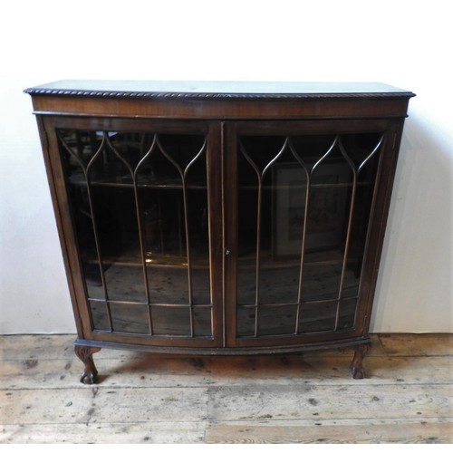 332 - AN EARLY 20TH CENTURY BOW FRONT GLAZED DISPLAY CABINET, on claw feet, 120 x 122 x 38 cm