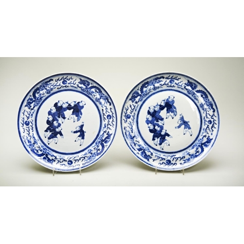 36 - PAIR OF BLUE AND WHITE 'BOYS' PLATESQING DYNASTY, 19TH CENTURYpainted with playful boys within a bor... 