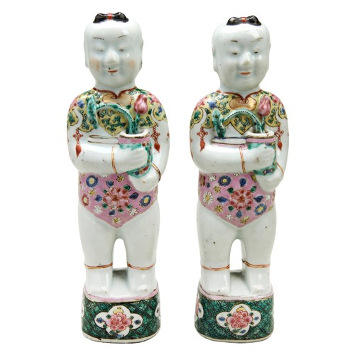 96 - PAIR OF FAMILLE ROSE BOYSQING DYNASTY, 18TH CENTURYstanding on square platforms painted with scrolli... 