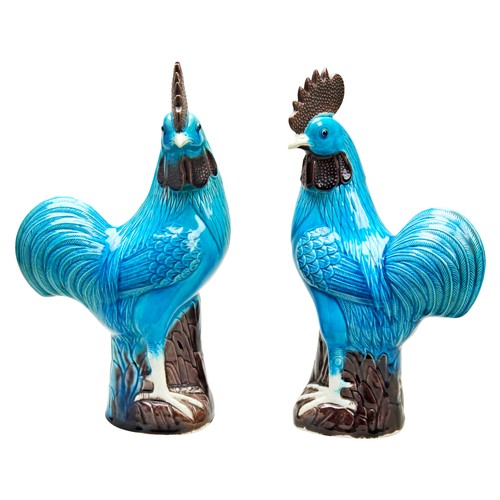 59 - PAIR OF TURQUOISE-GLAZED COCKERELS LATE QING DYNASTYeach standing astride a tree stump with heads tu... 