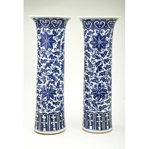 44 - PAIR OF BLUE AND WHITE 'LOTUS' SLEEVE VASESQING DYNASTY, 19TH CENTURYpainted in tones of underglaze ... 