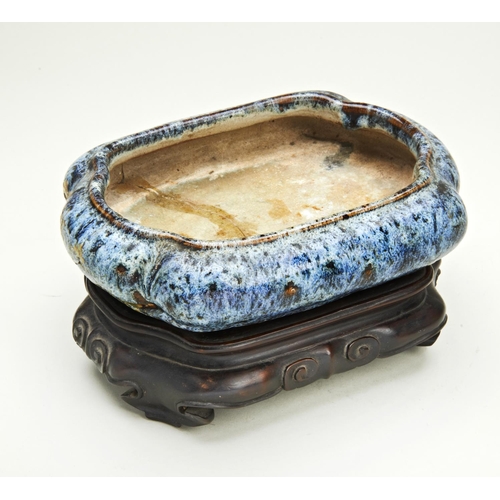 63 - FLAMBE-GLAZE BRUSHWASHERQING DYNASTY, 19TH CENTURYof lobed-form, raised on a fitted carved hardwood ... 