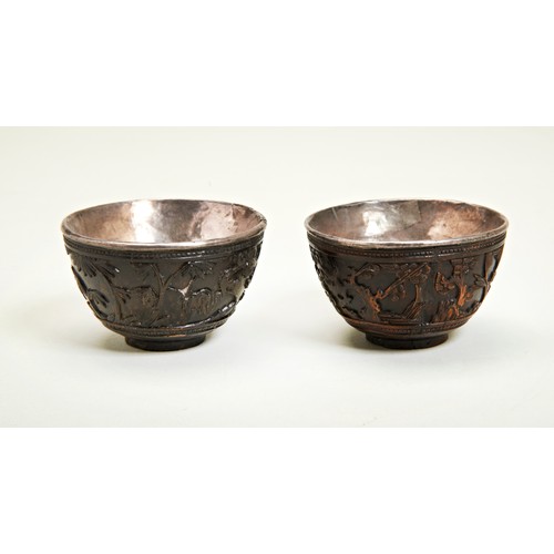 210 - PAIR OF CARVED COCONUT AND SILVER LINED WINE CUPSKANGXI PERIOD (1662-1722)the sides carved in relief... 