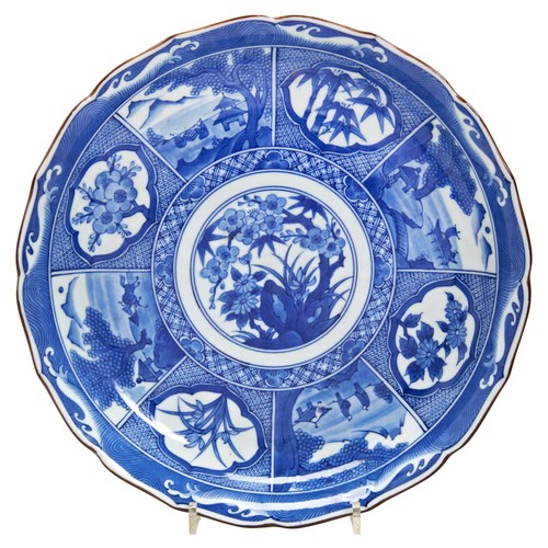 292 - JAPANESE BLUE AND WHITE BARBED DISH MEIJI PERIOD (1868-1912)painted with panels of landscape views a... 