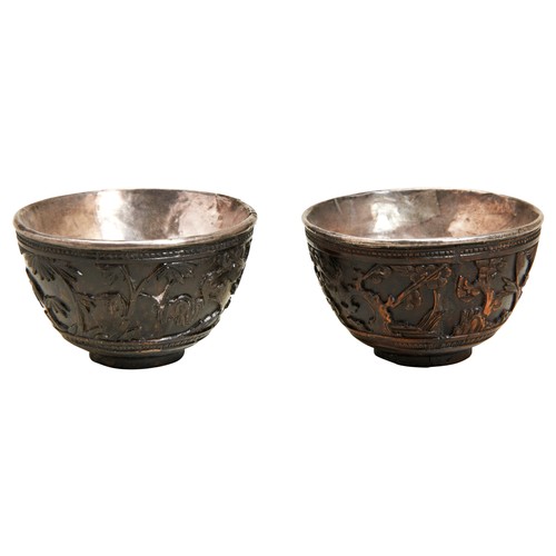 210 - PAIR OF CARVED COCONUT AND SILVER LINED WINE CUPSKANGXI PERIOD (1662-1722)the sides carved in relief... 