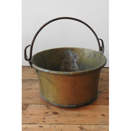 95 - A CONTINENTAL RIVETED BRASS BUCKET WITH IRON RING HANDLE, 52cm dia