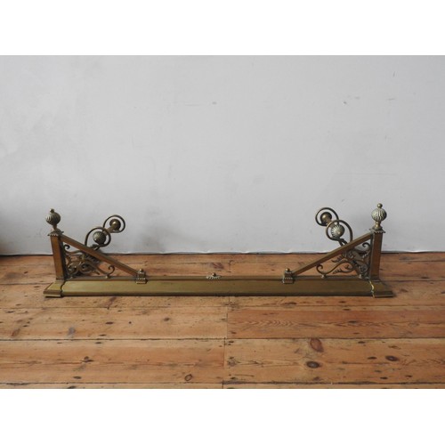 96 - AN ORNATE 19TH CENTURY BRASS FIRE CURB, with integrated fire dog rails, balloon finials and ornate f... 