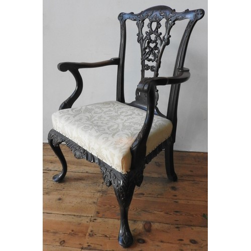 15 - A 19TH CENTURY ORNATE CARVED MAHOGANY ELBOW CHAIR, with an pierced carved splat back with ribbon and... 