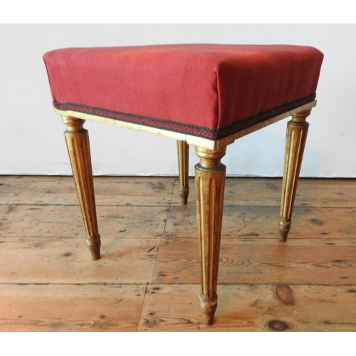 24 - A CONTINENTAL 19TH CENTURY GILT WOODEN STOOL, the upholstered square seat supported by four tapered ... 