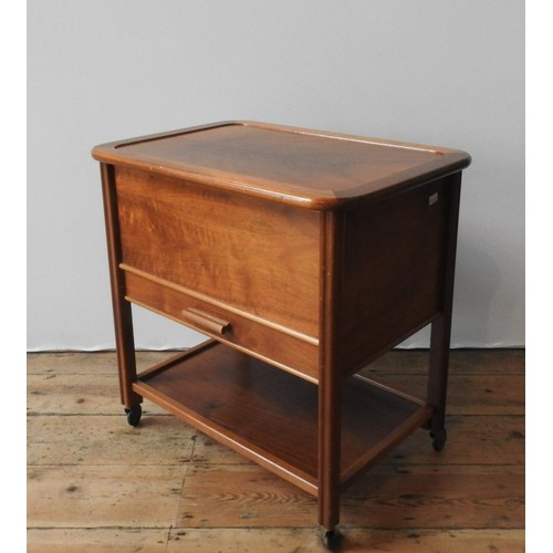 41 - A MID 20TH CENTURY MAHOGANY SEWING TABLE, with a lift top, shelf below, on four casters, 63 x 62 x 4... 