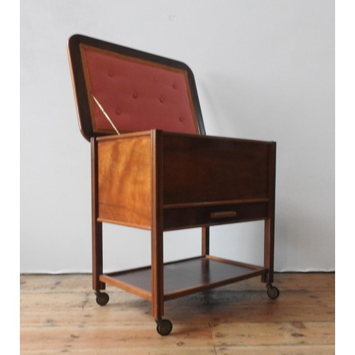 41 - A MID 20TH CENTURY MAHOGANY SEWING TABLE, with a lift top, shelf below, on four casters, 63 x 62 x 4... 