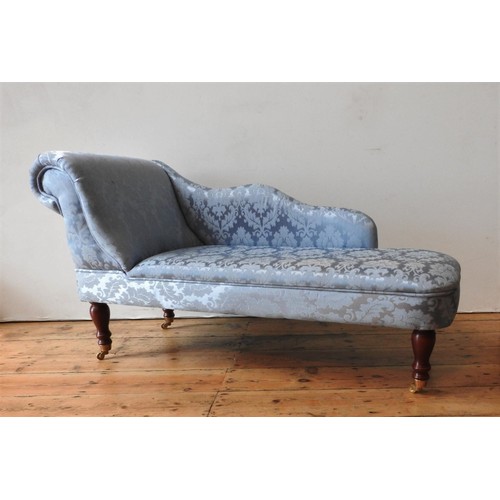 42 - A CHILD'S DAMASK UPHOLSTERED CHAISE LONGUE, covered in teal blue fabric with embroidered foliate des... 