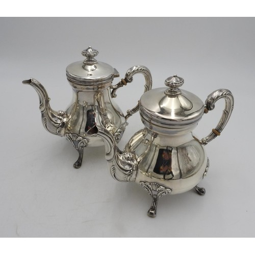 A PERUVIAN SILVER TEA AND COFFEE SERVICE BY CAMUSSO, comprising of a tea pot, coffee pot, hot water pot, milk jug and strainer, all stamped 925. 