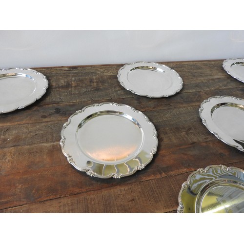 424 - A SET OF TEN PERUVIAN SILVER DINNER PLATES BY CAMUSSO, with lotus flower motif to border, 30 cm dia,... 