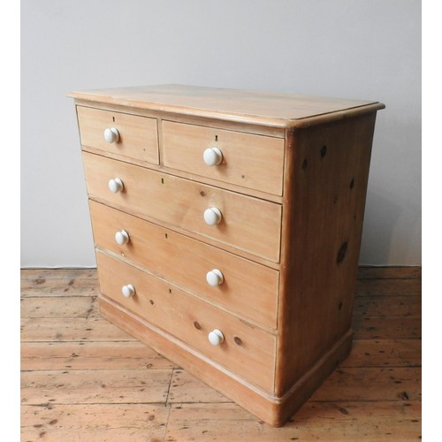 58 - A VICTORIAN WAXED PINE CHEST OF FIVE DRAWERS, two short drawers over three long drawers, with china ... 