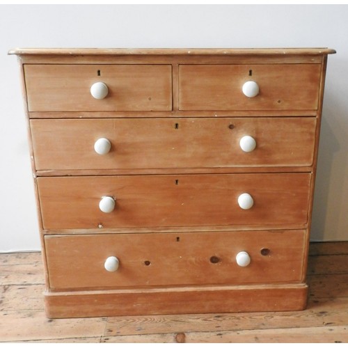 58 - A VICTORIAN WAXED PINE CHEST OF FIVE DRAWERS, two short drawers over three long drawers, with china ... 