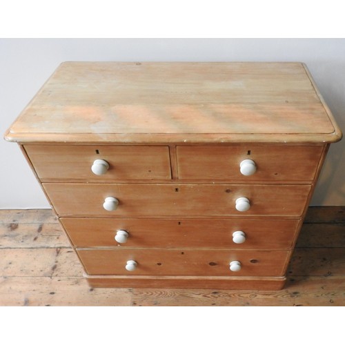 58 - A VICTORIAN WAXED PINE CHEST OF FIVE DRAWERS, two short drawers over three long drawers, with china ... 