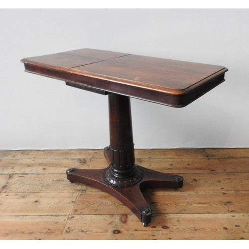 61 - A VICTORIAN MAHOGANY TABLE WITH TWO WRITING SLOPE SECTIONS, on a tulip carved pedestal with an X-sha... 