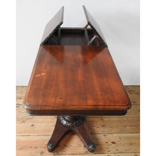 61 - A VICTORIAN MAHOGANY TABLE WITH TWO WRITING SLOPE SECTIONS, on a tulip carved pedestal with an X-sha... 