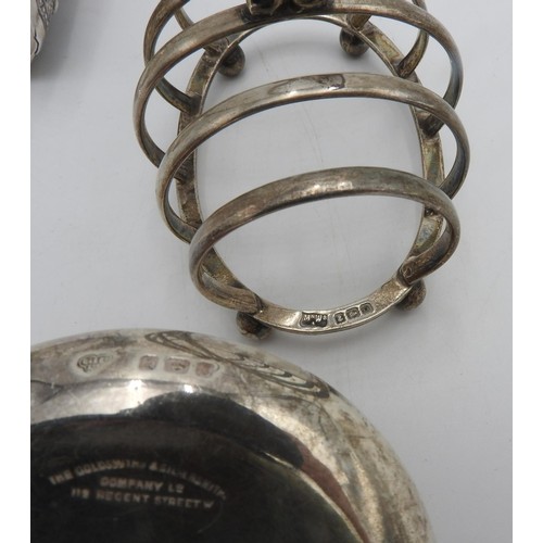 434 - A HALLMARK SILVER TOAST RACK AND PIN TRAY, AND AN ASIAN SILVER BANGLE, the bangle decorated with mer... 