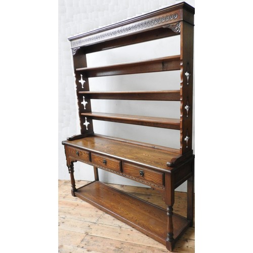 73 - A 20TH CENTURY OAK DRESSER WITH PLATE RACK, the dresser base with three drawers and open shelf below... 