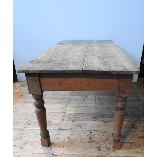 77 - A WAXED PINE RUSTIC FARMHOUSE TABLE, on turned legs 78 x 180 x 87 cm