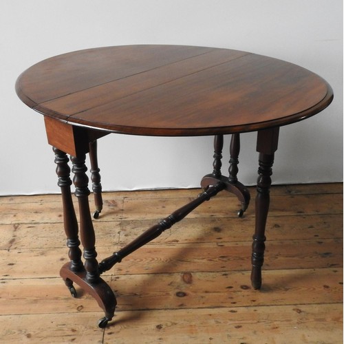 82 - A VICTORIAN MAHOGANY SUTHERLAND TABLE, the folding circular top supported on turned legs and stretch... 