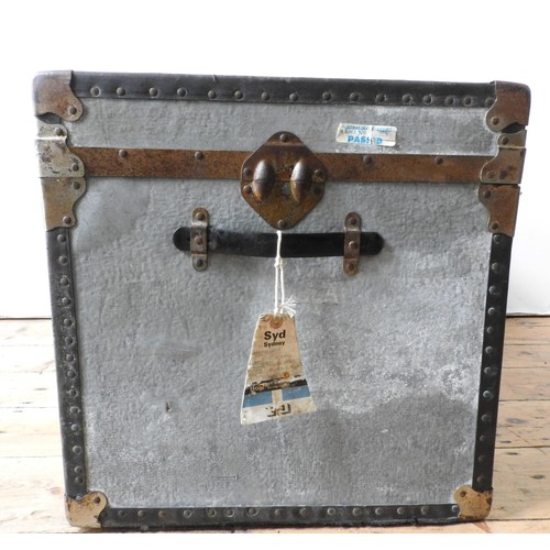 84 - A TIN COVERED VINTAGE TRAVEL TRUNK, with two handles, latches and vintage air travel labels attached... 