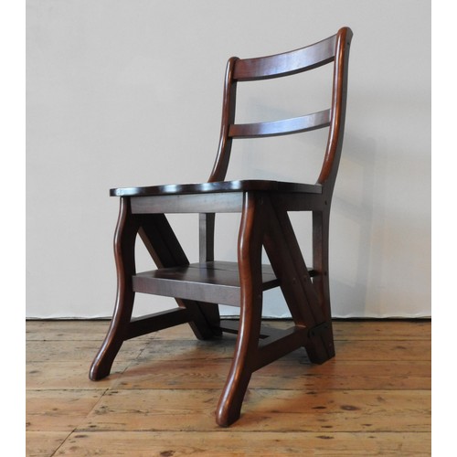 85 - A METAMORPHIC HARDWOOD LIBRARY CHAIR, the hinged seat folding over to form a four tread library step... 