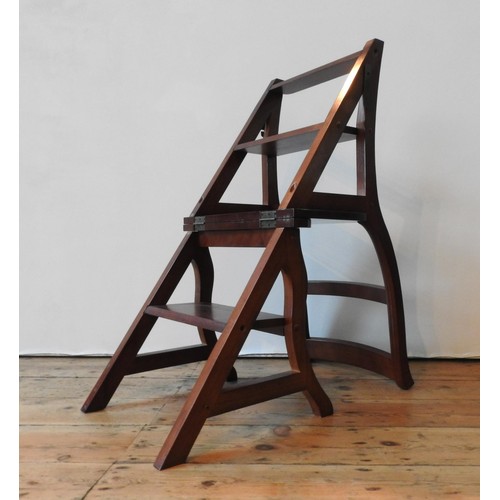 85 - A METAMORPHIC HARDWOOD LIBRARY CHAIR, the hinged seat folding over to form a four tread library step... 