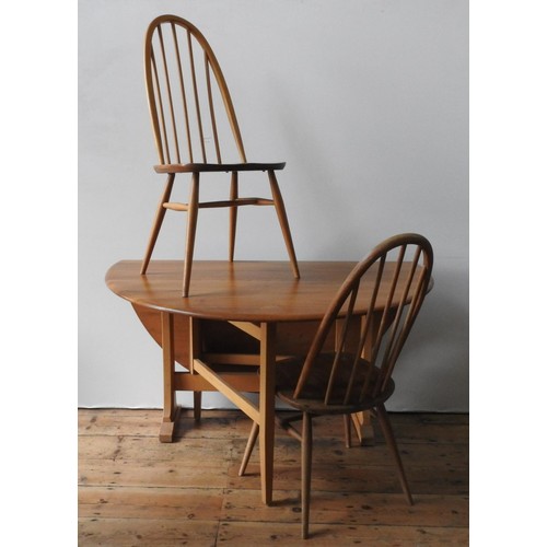 86 - AN ERCOL LIGHT WOOD DROP-LEAF TABLE AND FOUR ERCOL HIGH BACK SPINDLE CHAIRS, the chairs measuring 97... 