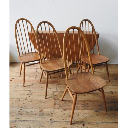 86 - AN ERCOL LIGHT WOOD DROP-LEAF TABLE AND FOUR ERCOL HIGH BACK SPINDLE CHAIRS, the chairs measuring 97... 